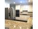 This kitchen features white cabinets, stainless steel appliances, and granite countertops at 30 Highlands Ln, Oxford, GA 30054