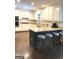 A well-lit kitchen with white cabinets, granite countertops, and a breakfast bar at 30 Highlands Ln, Oxford, GA 30054