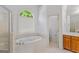 Bathroom features a soaking tub, step-in shower and great natural light at 1500 Royce Dr, Locust Grove, GA 30248