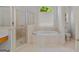 Bathroom has a luxurious soaking tub and a separate glass shower at 1500 Royce Dr, Locust Grove, GA 30248