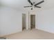 Bedroom boasts neutral carpet, ceiling fan, and multiple closets at 1500 Royce Dr, Locust Grove, GA 30248