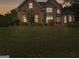 Charming brick home with manicured lawn and mature landscaping at 1500 Royce Dr, Locust Grove, GA 30248