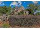 Brick home featuring well-maintained bushes, lawn, trees, and driveway in a quiet neighborhood at 1500 Royce Dr, Locust Grove, GA 30248