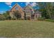 Charming brick home with manicured lawn, mature trees, and lovely landscaping in a desirable location at 1500 Royce Dr, Locust Grove, GA 30248