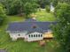 Aerial view of a home with a screened porch, deck, and outdoor fireplace surrounded by lush greenery at 3290 Ebenezer Se Rd, Conyers, GA 30094