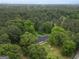 Aerial shot showcases a secluded home nestled in a lush forest, promising privacy and serene living at 3290 Ebenezer Se Rd, Conyers, GA 30094