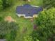 Aerial view of a home with a screened porch, deck, and outdoor fireplace surrounded by lush greenery at 3290 Ebenezer Se Rd, Conyers, GA 30094