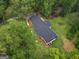 An aerial view showcases the home and its well-maintained grounds and surrounding trees at 3290 Ebenezer Se Rd, Conyers, GA 30094
