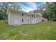 Back exterior view of home with sunroom and lots of green space at 3290 Ebenezer Se Rd, Conyers, GA 30094
