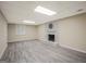Finished basement featuring new flooring, a white brick fireplace, and neutral paint at 3290 Ebenezer Se Rd, Conyers, GA 30094