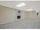 Finished basement with neutral walls, plank flooring, and a decorative, painted-brick fireplace at 3290 Ebenezer Se Rd, Conyers, GA 30094
