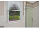 Bathroom featuring bright window views and a glass-enclosed shower at 3290 Ebenezer Se Rd, Conyers, GA 30094