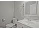 Clean bathroom with white fixtures, a decorative mirror, and neutral tones for a simple and functional space at 3290 Ebenezer Se Rd, Conyers, GA 30094