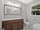 Bathroom featuring a double vanity, framed mirror, and a white toilet with marble floors at 3290 Ebenezer Se Rd, Conyers, GA 30094