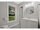 Bright bathroom with a window overlooking a green yard, complemented by neutral colors and modern fixtures at 3290 Ebenezer Se Rd, Conyers, GA 30094