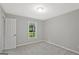 Bright bedroom with neutral carpet and a window offering a view of the green yard, creating a serene atmosphere at 3290 Ebenezer Se Rd, Conyers, GA 30094