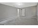Spacious bedroom featuring neutral gray walls, plush gray carpet, and natural light at 3290 Ebenezer Se Rd, Conyers, GA 30094