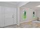 Light filled entryway with wood flooring, white trim, and white front door with sidelights at 3290 Ebenezer Se Rd, Conyers, GA 30094