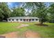 Charming single-story home with manicured lawn, bright red front door, and classic white columns at 3290 Ebenezer Se Rd, Conyers, GA 30094