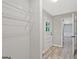 Hallway with view of the outside, shelving for storage and wood-look floors at 3290 Ebenezer Se Rd, Conyers, GA 30094