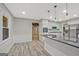 Open-concept kitchen with island seating, stainless appliances, gray countertops, white cabinetry, and hardwood floors at 3290 Ebenezer Se Rd, Conyers, GA 30094