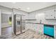 Updated kitchen features stainless steel refrigerator, light countertops and backsplash, and stylish blue dishwasher at 3290 Ebenezer Se Rd, Conyers, GA 30094