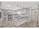 Open kitchen featuring an island, white cabinets, subway tile backsplash, and stainless steel appliances at 3290 Ebenezer Se Rd, Conyers, GA 30094