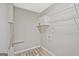 Functional laundry area with a metal shelving unit and gray walls and wood-look flooring at 3290 Ebenezer Se Rd, Conyers, GA 30094