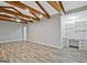 Open living area with hardwood floors, built-in desk/shelving unit, and high, decorative beamed ceilings at 3290 Ebenezer Se Rd, Conyers, GA 30094