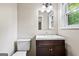 Bathroom with modern vanity, white toilet, and framed mirror at 5724 Amalfi Way, Douglasville, GA 30135