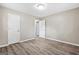 Bedroom with hardwood floors, neutral walls, ceiling light, and open door at 5724 Amalfi Way, Douglasville, GA 30135
