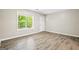 Bedroom featuring wood-look flooring and natural light from a window at 5724 Amalfi Way, Douglasville, GA 30135