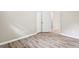 Empty room with wood-look flooring and neutral walls and an open door at 5724 Amalfi Way, Douglasville, GA 30135