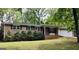 Charming brick home with black shutters, a well-manicured lawn, and mature trees at 5724 Amalfi Way, Douglasville, GA 30135