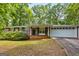 Brick ranch-style home with a white garage door and mature landscaping at 5724 Amalfi Way, Douglasville, GA 30135