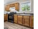 Close up of a kitchen with wood cabinets and a black oven at 5724 Amalfi Way, Douglasville, GA 30135