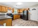 Classic kitchen features wood cabinets, dark countertops, and a modern black refrigerator at 5724 Amalfi Way, Douglasville, GA 30135