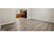 Spacious living room with laminate flooring, looking towards the kitchen at 5724 Amalfi Way, Douglasville, GA 30135