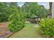 Backyard view featuring an inviting gazebo seating area surrounded by mature trees at 12323 Styron Dr, Hampton, GA 30228