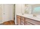 Bathroom with double sinks, wood cabinets, and a view to the shower area at 12323 Styron Dr, Hampton, GA 30228