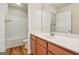 Bright bathroom features wood-look floors, vanity with white countertop, and shower-tub combo at 12323 Styron Dr, Hampton, GA 30228
