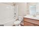 Well-lit bathroom with a shower-tub combo, toilet, and vanity with storage at 12323 Styron Dr, Hampton, GA 30228