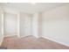 Empty bedroom with double doors, carpet flooring, and a window for natural light at 12323 Styron Dr, Hampton, GA 30228