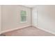 Cozy bedroom features neutral walls, plush carpeting, and a window with blinds at 12323 Styron Dr, Hampton, GA 30228