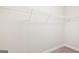 Empty closet with white wire shelving and neutral carpeting at 12323 Styron Dr, Hampton, GA 30228