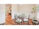 Elegant dining room with a glass table, stylish chairs, and hardwood flooring at 12323 Styron Dr, Hampton, GA 30228