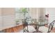 Charming dining area with a glass table, comfortable seating, and bright natural light at 12323 Styron Dr, Hampton, GA 30228