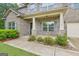 Inviting front porch features brick columns and lush landscaping for a welcoming entry at 12323 Styron Dr, Hampton, GA 30228