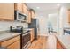 Well-equipped kitchen with stainless steel appliances, wooden cabinetry, and granite countertops at 12323 Styron Dr, Hampton, GA 30228