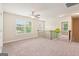 A spacious loft with natural lighting, carpeted floors, and neutral colored walls at 12323 Styron Dr, Hampton, GA 30228